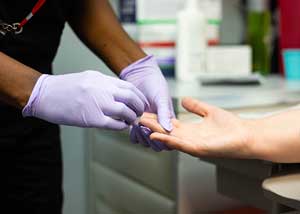 Close up of hand receiving STI Test