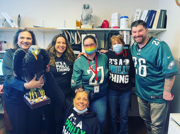 Six people in green eagles jerseys