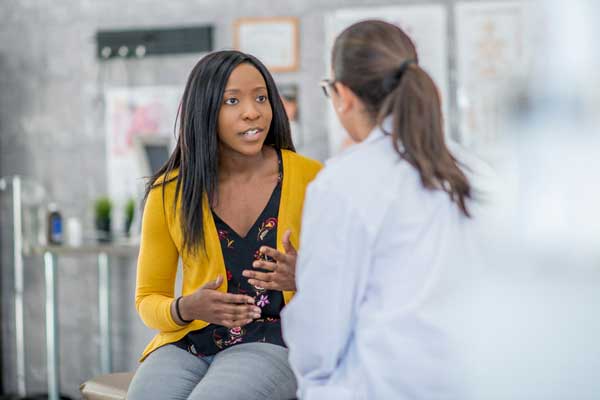 Woman speaking to doctor